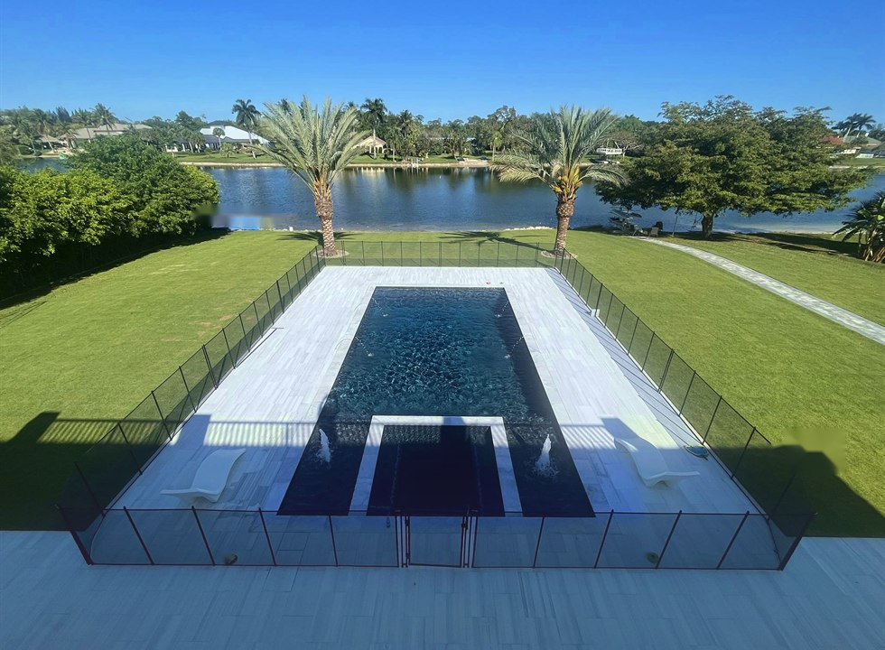 Long custom pool with lake view